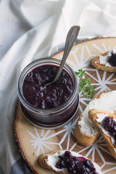 Crostini platter with a jar of blueberry-onion jam